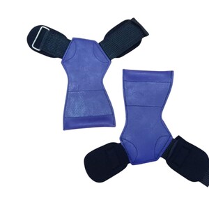 May include: Two blue weightlifting grips with black wrist straps. The grips are made of a textured material and have a contoured shape for a secure hold. The wrist straps have a metal buckle for adjustment.