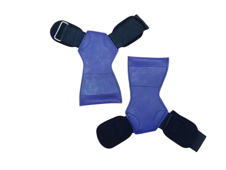 May include: Two blue weightlifting grips with black wrist straps. The grips are made of a textured material and have a contoured shape for a secure hold. The wrist straps have a metal buckle for adjustment.