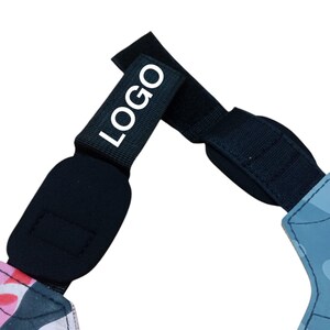 May include: Black adjustable strap with the white text "LOGO". The strap is connected to a pink and black camouflage pattern and a blue camouflage pattern. The strap has a velcro closure.