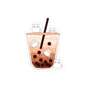 May include: A sticker featuring a cute illustration of a bubble tea drink with adorable white bear characters. The drink has a gradient of brown and tan colors, with dark brown boba pearls and a black straw. The bears are positioned around the drink.