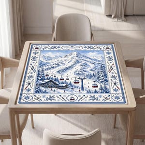 May include: A square table mat featuring a blue and white winter mountain scene with a ski resort, cable cars, and pine trees. The border displays snowflakes, crossed skis, and the word Personalized at the top center in a decorative frame.
