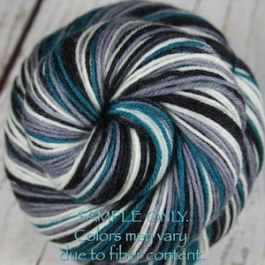 May include: A skein of yarn with black, white, teal, and gray stripes. The yarn is wound into a ball shape. The text "SAMPLE ONLY. Colors may vary due to fiber content." is printed on the bottom of the image.