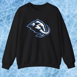 May include: Black crew neck sweatshirt with a white and light blue elephant head logo. The logo is a stylized design with a mountain-like shape and a curved tusk. The sweatshirt is a solid color and has a casual style.