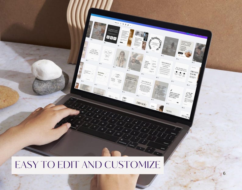 May include: A laptop displaying a design interface with various templates. The screen shows multiple layouts with text and images. The text "EASY TO EDIT AND CUSTOMIZE" is at the bottom of the screen. A stack of stones and a wooden decorative piece are on the table.