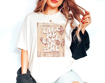May include: A white t-shirt with a vintage-style graphic that says "Take Me Back In Time" with palm trees in the background.
