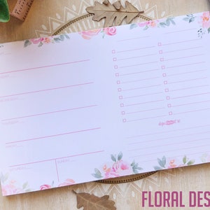 May include: A pink floral weekly planner with a floral design on the cover. The planner has a section for each day of the week and a section for notes. The planner is perfect for organizing your week.