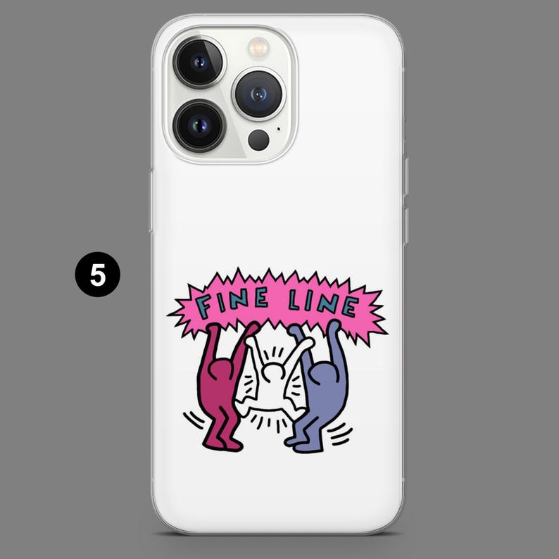 May include: White phone case with a graphic design featuring three stylized figures holding up a pink banner with the words "FINE LINE" in blue and pink. The case has a clear border and a gray background.