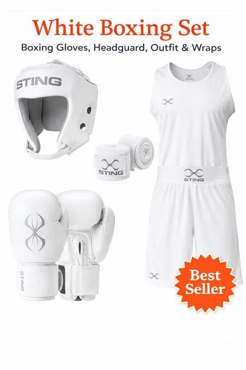 May include: White boxing set including gloves, headgear, wraps, and a matching outfit. The set features white boxing gloves with a stylized design, a headguard, and hand wraps. The outfit includes a tank top and shorts.