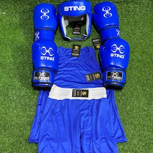 May include: A complete blue boxing set, including gloves, headgear, a tank top, and shorts. The gloves and headgear have the word "STING" printed on them. The shorts have a white waistband.