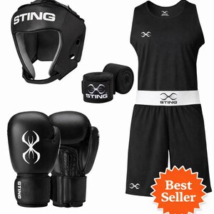 May include: Black boxing set including gloves, headgear, outfit, and wraps. The set features black boxing gloves, a headguard, a black tank top and shorts with a white waistband, and black hand wraps. The brand name "STING" is visible on multiple items.