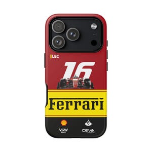 May include: A phone case with a red, black, and yellow design, featuring a Formula 1 race car. The case displays the number 16 and the Ferrari logo. The bottom section includes the VGW Play and CEVA Logistics logos.