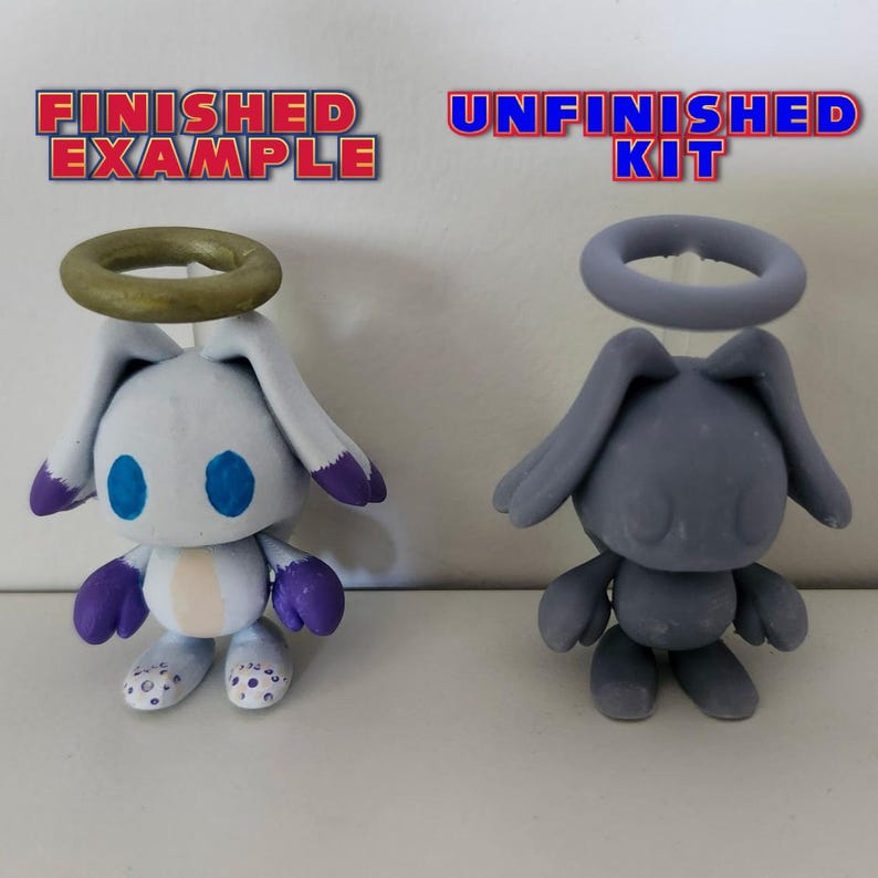 May include: A finished and unfinished figurine of a white and grey angel with a halo. The finished figurine is painted white with blue eyes and purple accents. The unfinished figurine is grey and unpainted.