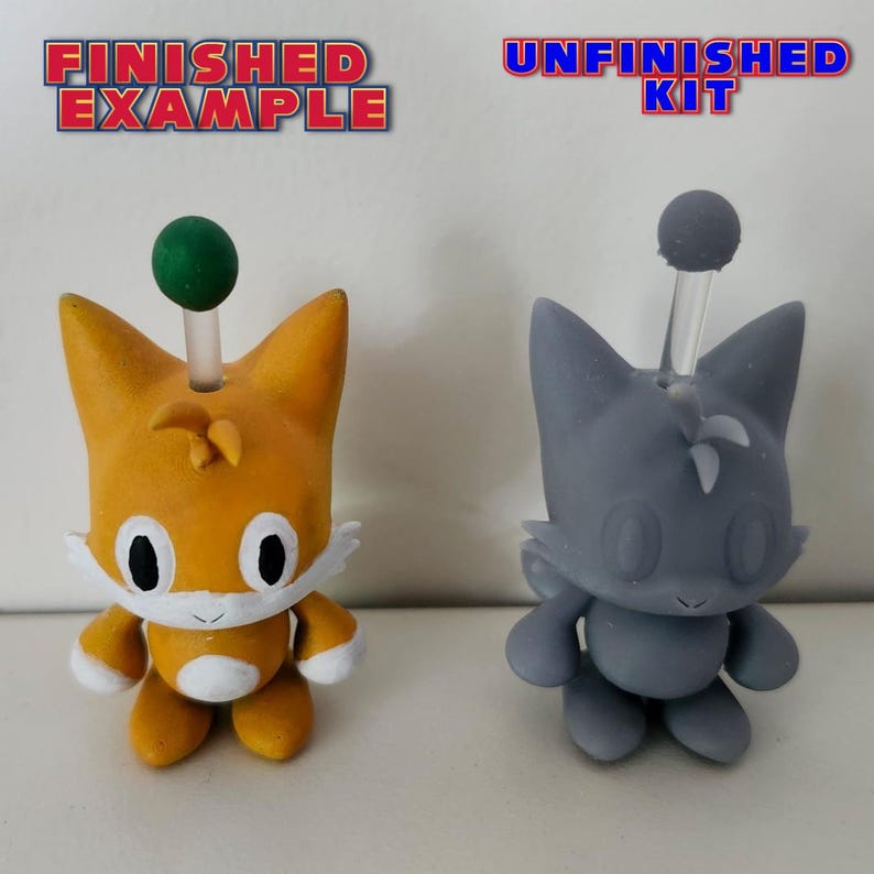 May include: A finished and unfinished kit of a small, orange and grey, cartoon character with a green and white antenna. The finished character is orange with white accents and the unfinished character is grey. The text "FINISHED EXAMPLE" is above the finished character and the text "UNFINISHED KIT" is above the unfinished character.