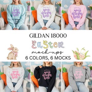 Op de afbeelding: Een verzameling van zes Gildan 18000 sweatshirts in verschillende kleuren: lichtblauw, wit, roze, zwart en grijs. Elk sweatshirt heeft de tekst "mock nest your design here". De afbeelding bevat ook Pasen-thema graphics en tekst.