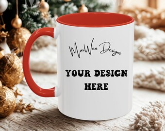 May include: White ceramic mug with a red interior and handle. The mug features the text "MarWen Designs" in a script font above the words "YOUR DESIGN HERE" in a bold, blocky font. The mug is set against a blurred background.