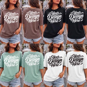 May include: A collection of short-sleeved t-shirts in various colors, including brown, black, green, and white. Each shirt features the text "Your Design Here" in a stylized font on the front and back.