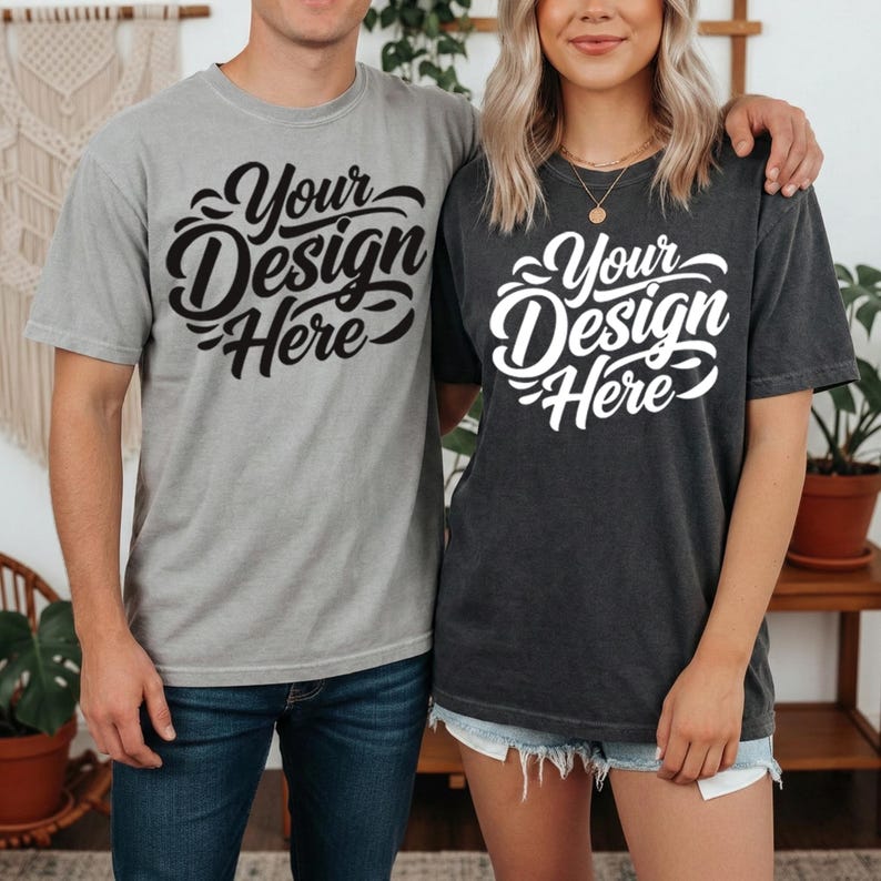 May include: Two people wearing matching gray and charcoal t-shirts. Each shirt has the text "Your Design Here" in a stylized script. The shirts are short-sleeved and appear to be made of a soft, comfortable material.