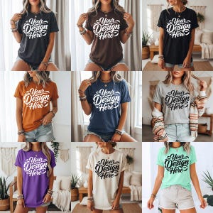 Może przedstawiać: Kolekcja dziewięciu koszulek w różnych kolorach, w tym antracytowym, brązowym, czarnym, pomarańczowym, granatowym, szarym, fioletowym, kremowym i miętowym. Każda koszulka ma napis "Your Design Here" w ozdobnym stylu.