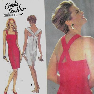 May include: Simplicity sewing pattern featuring a Christie Brinkley Collection design. The pattern includes illustrations of two dresses, one red and one white. The text "easy to sew" is visible.