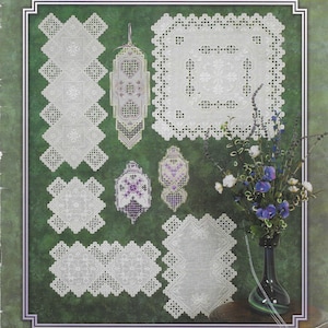 May include: A pattern booklet titled Mary's Hardanger Fancies by Mary Swartz, compiled by Susan L. Meier and Rosalyn K. Watnemo. The cover displays various white Hardanger embroidery designs on a green background, alongside a vase of flowers.