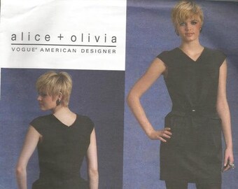 May include: A black sleeveless dress with a V-neckline and a belt. The dress has a fitted bodice and a flared skirt. The dress is shown on a model with short blonde hair. The pattern is for Vogue American Designer, Alice + Olivia, V1122.