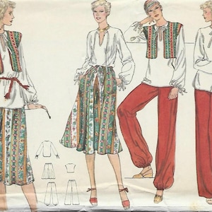 May include: A vintage sewing pattern for a women's top and pants or skirt. The pattern is for size 14 and is from Vogue Patterns. The pattern is called "Very Easy" and is for a white top with a gathered neckline and long sleeves, and a choice of either a red pair of pants with a wide leg or a green and white floral skirt.
