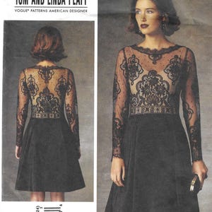 May include: A black dress sewing pattern by Tom and Linda Platt. The dress features a sheer lace bodice and long sleeves, with a flared skirt. The pattern includes sizes 16-18-20-22-24. The Vogue Patterns American Designer logo is visible.