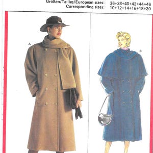 May include: A vintage Burda sewing pattern, number 5219, featuring illustrations of two women's coats. One is a tan double-breasted coat with a scarf, and the other is a blue cape-style coat. The pattern includes European and corresponding sizes.