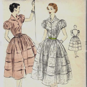 May include: Vintage Vogue pattern featuring illustrations of two dresses with tiered skirts and puffed sleeves. The pattern is size 16, with a 34-inch bust and 37-inch hip. The text "VOGUE PATTERN" is visible.