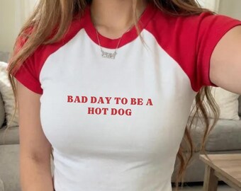 Bad Day To Be A Hot Dog Raglan Baby Tee, Funny 4th Of July Shirt, Retro Hot Dog Graphic Top, Patriotic Women’s Baby Tee, Memorial Day BBQ