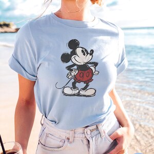 May include: A trio of ceramic mugs with a speckled, matte finish in cream, light grey, and dark grey. Each mug features a simple, minimalist design, ideal for tea or coffee.