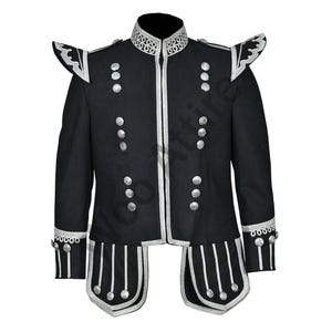 Pode incluir: Casaco preto de estilo militar com detalhes prateados. O casaco apresenta gola alta, ombreiras decorativas e vários botões prateados. As bordas, punhos e painéis decorativos são contornados por detalhes prateados. Vestuário formal.