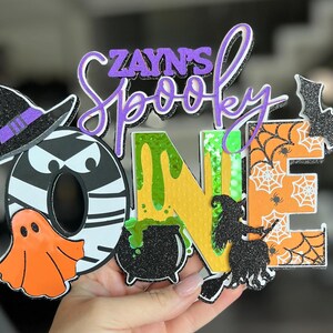 Halloween 1st Birthday Cake Topper - &quot;Spooky One&quot; | Custom Halloween Name Topper | Glittered Layered Cake Decoration | Spooky Birthday Decor