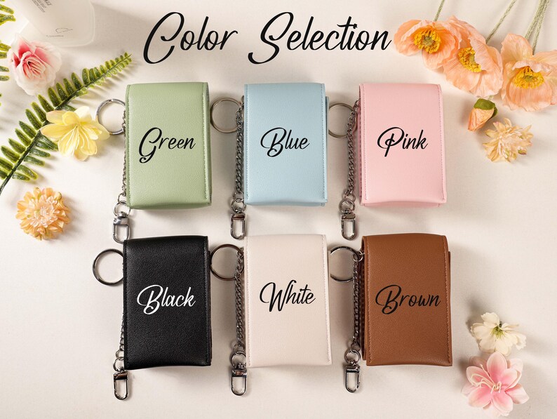 May include: A selection of keychains in various colors: green, blue, pink, black, white, and brown. Each keychain has a metal chain and ring. The words "Color Selection" are written at the top of the image.
