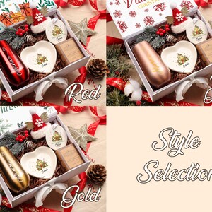 May include: Christmas gift boxes with a tumbler, heart-shaped dish, soap, and ornaments. The boxes are labelled "Red", "Rose Golden", and "Gold". Festive decorations include pine cones, stars, and ribbons.