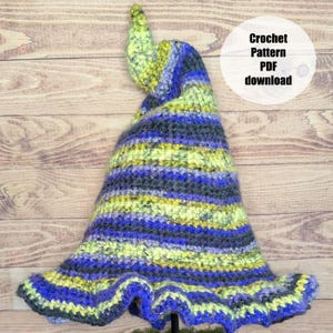 May include: A pointed crochet hat featuring a variegated yarn pattern in shades of lime green, royal blue, and charcoal gray. The hat has a wide, ruffled brim and a tall, slightly curved tip. Text on the image reads: Crochet Pattern PDF download.