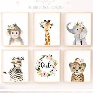 May include: A set of six nursery prints featuring watercolor illustrations of animals wearing floral crowns. The animals include a monkey, giraffe, elephant, zebra, cheetah, and a floral wreath with the name "Carla".