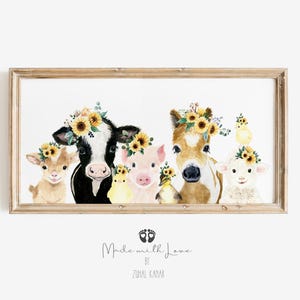 May include: A watercolor painting of a cow, pig, horse, goat, and two chicks wearing sunflower crowns. The animals are all looking at the viewer. The painting is framed in a light wood frame. The text "Made with Love by Zuhra Kamar" is printed below the image.