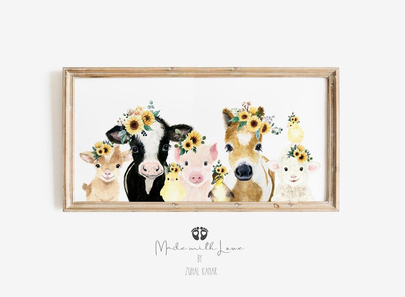 May include: A watercolor painting of a cow, pig, horse, goat, and two chicks wearing sunflower crowns. The animals are all looking at the viewer. The painting is framed in a light wood frame. The text "Made with Love by Zuhra Kamar" is printed below the image.