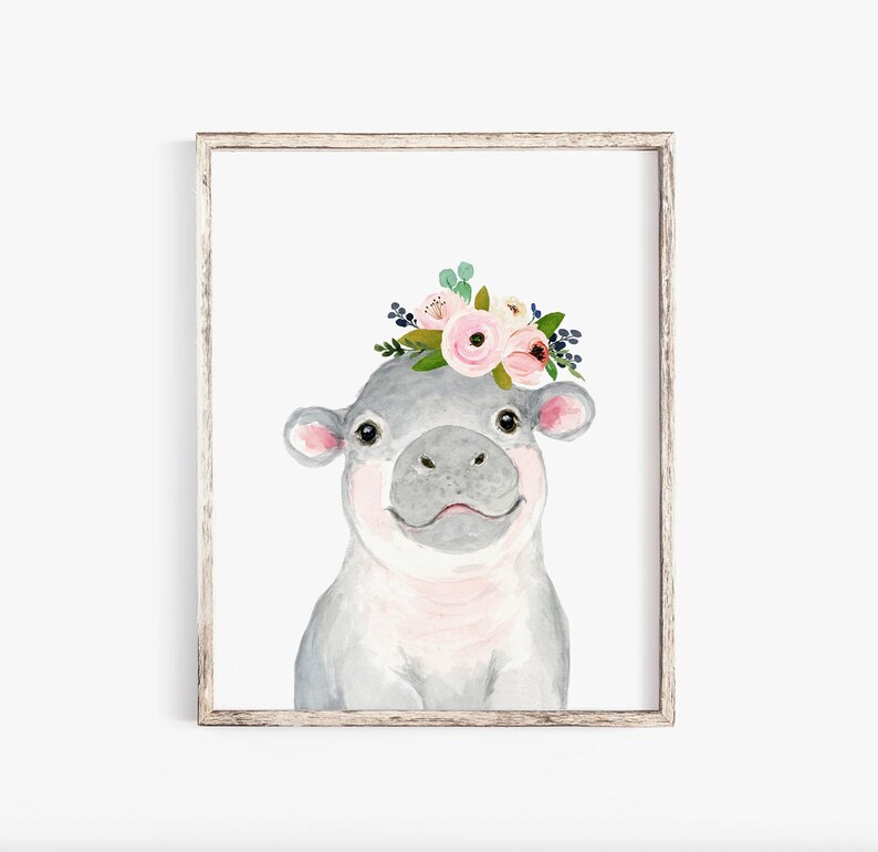 Pode incluir: Uma pintura em aquarela de um hipop&oacute;tamo cinza com o nariz rosa e uma coroa floral de flores rosa e brancas. O hipop&oacute;tamo est&aacute; olhando diretamente para o espectador.