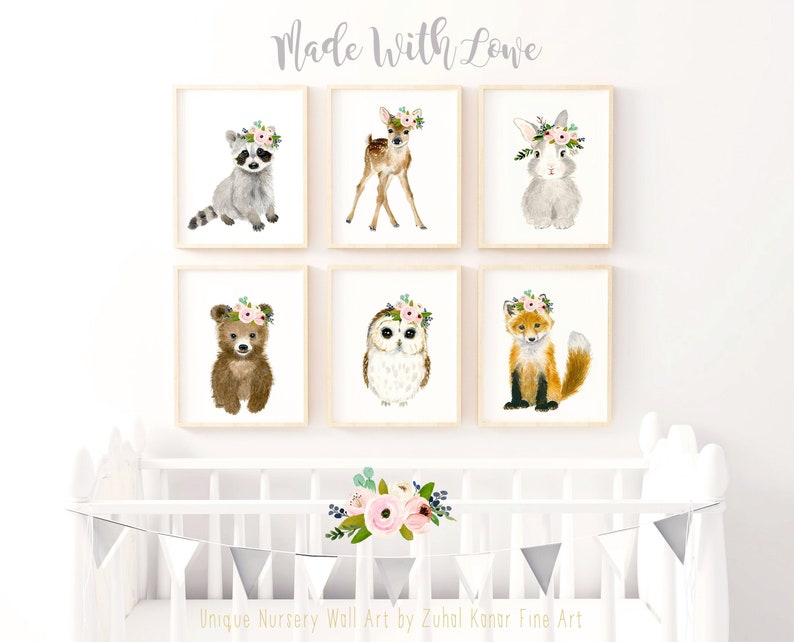 May include: Set of six watercolor animal prints featuring a raccoon, deer, rabbit, bear, owl, and fox. Each animal is wearing a floral crown. The prints are perfect for a nursery or child's room.