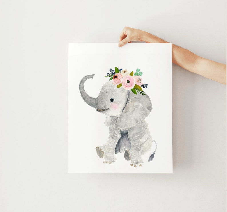 May include: A watercolor painting of a gray elephant wearing a pink and green floral crown. The elephant is sitting on its hind legs with its trunk raised.