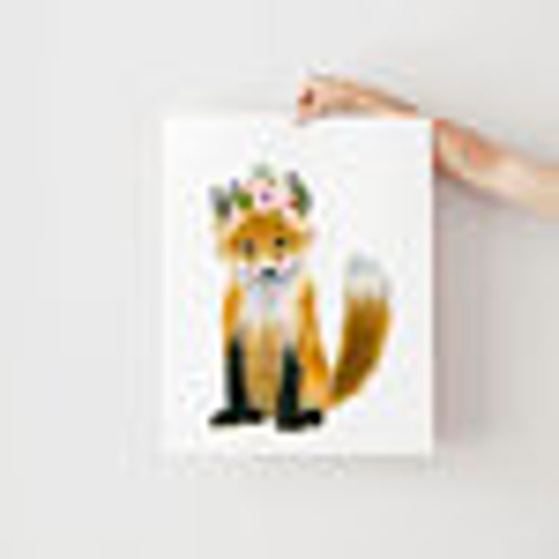May include: Watercolor painting of a fox with a brown and orange body, black legs and tail, and a white chest. The fox is sitting on a white background with a light blue watercolor splatter pattern.