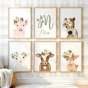 May include: Set of six framed prints featuring watercolor illustrations of farm animals wearing floral crowns. The prints include a pig, a horse, a goat, a cow, and two initial letters with a floral design. The prints are all in a light wood frame and have a white background.