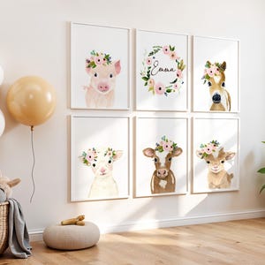 May include: Set of six framed prints featuring watercolor illustrations of farm animals wearing flower crowns. The animals include a pig, a cow, a lamb, a goat, a horse, and a wreath with the name "Emma".