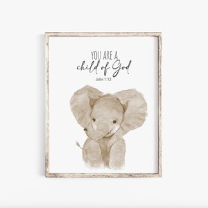 May include: A framed print featuring a watercolour illustration of a brown elephant and the text "You are a child of God" with the scripture reference "John 1:12".