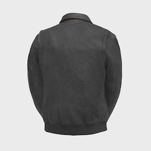 May include: A black leather jacket with a classic bomber style. The jacket features a collar, a ribbed hem, and ribbed cuffs. The back view shows the jacket's design and stitching details. The jacket is a versatile outerwear piece.