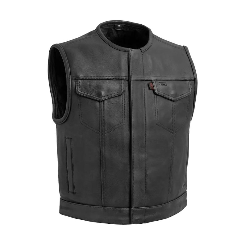 May include: Black leather vest with a round collar and two chest pockets. The vest has a front closure and a small red tag on the right chest pocket. The vest is sleeveless and has a medium size.