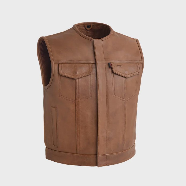 May include: A brown leather vest with a mandarin collar and two front pockets. The vest has a classic design with a tailored fit. The vest has a small red tag on the right pocket.