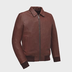 May include: A brown leather jacket with a collar and a full-length zipper. The jacket has a ribbed hem and cuffs. The jacket has two side pockets. The leather has a slightly distressed appearance.